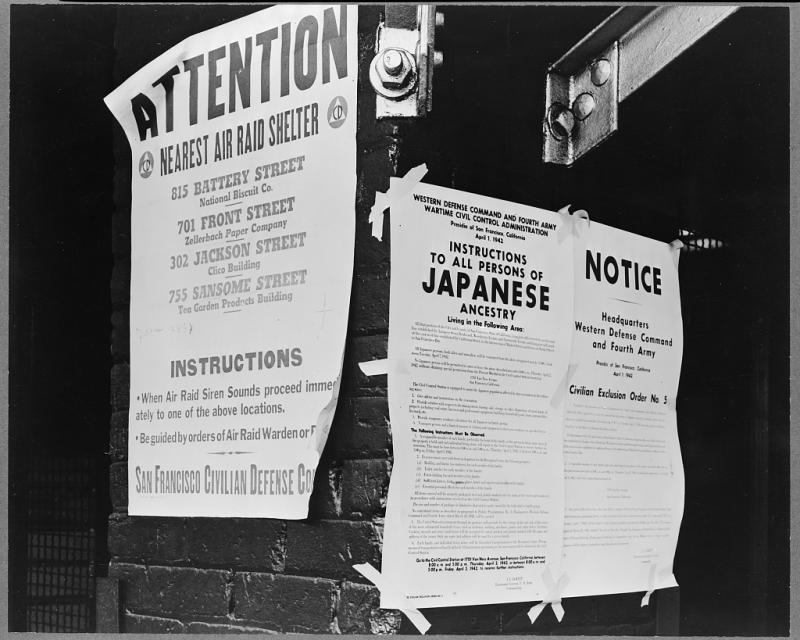 Civilian exclusion order #5 A wartime relocation poster on a wall. There are three pieces of it. It is full of information.