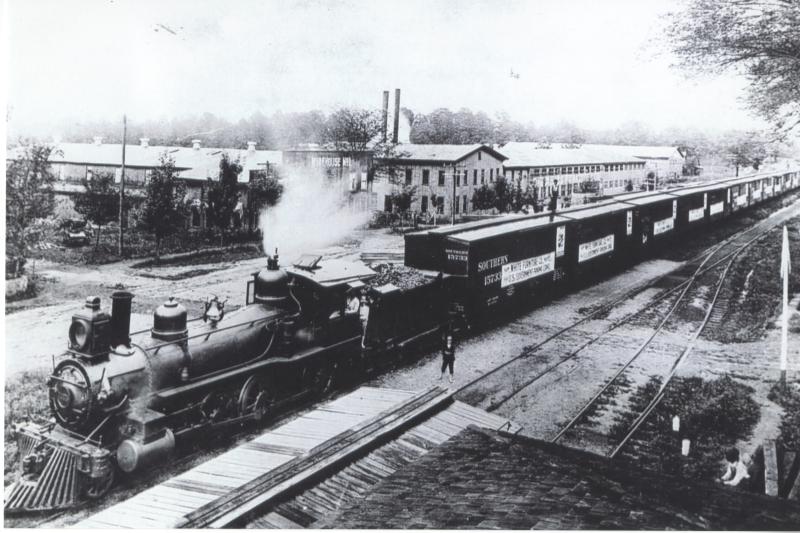 Mebane Panama Canal Train 1906 Photograph of a cargo train loading furniture at the White Furniture Company in Mebane, N.C. , 1906. The train was headed for the Panama Canal. From the collection of the Alamance County Public Library, available at DigitalNC.