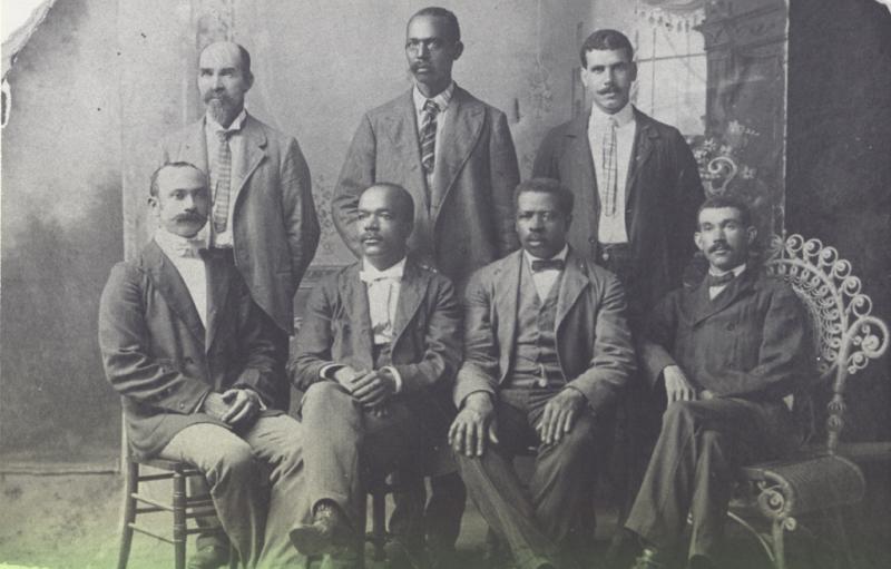 Some of the Founders of Mechanics & Farmers Bank Six men in suits pose for a photo. Black and white photo.