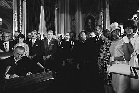Voting Rights Act (1965) In this photo President Lyndon B. Johnson signs the Voting Rights Act as Martin Luther King Jr. and other civil rights leaders look on, August 6, 1965, United States Capitol, Washington, D.C.