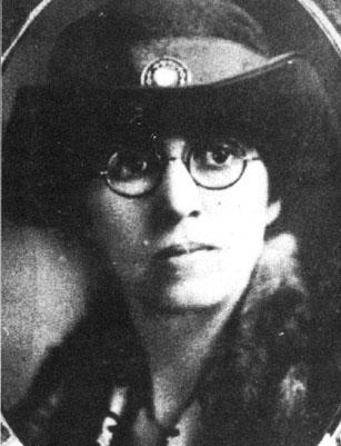 Lillian Exum Clement Lilian Exum Clement. She is facing the camera. She is wearing glasses and a fancy hat with a jewel on the front of it. Her lips are pursed. Black and white.