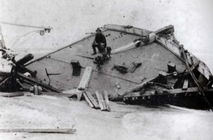 The Priscilla wrecked during the hurricane of 1899. Rasmus Midgett, sitting on the wreckage, saved ten people from the ship during the hurricane, Hatteras, NC. Image courtesy of the NC Office of Archives and History, call #: PhC42_Bx6_Boats and Boating_F19. The Priscilla wrecked during the hurricane of 1899. Rasmus Midgett, sitting on the wreckage, saved ten people from the ship during the hurricane. Image courtesy of the NC Office of Archives and History via East Carolina University.
