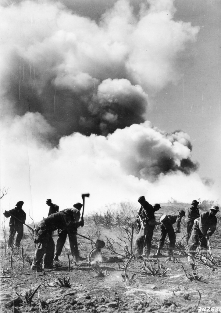 Members of the Civilian Conservation Corps performing a controlled burn.