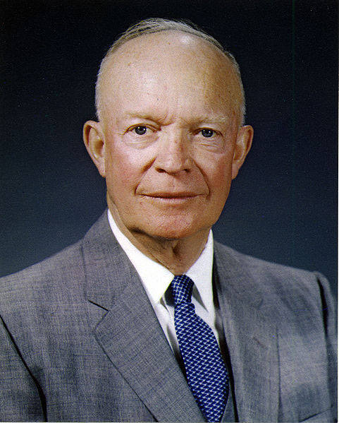 Dwight D. Eisenhower portrait. He is balding, and smiling. He is wearing a suit.